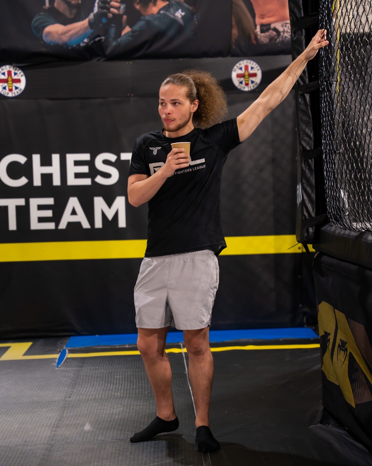 Ellis holding pads during sparring
